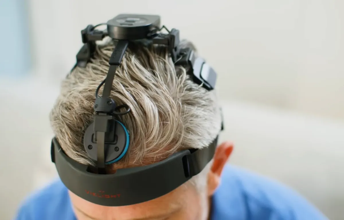 The neuro-performance headset worn on the head, showing module placement and the adjustable headband